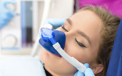Woman receiving gas anesthesia at dentist