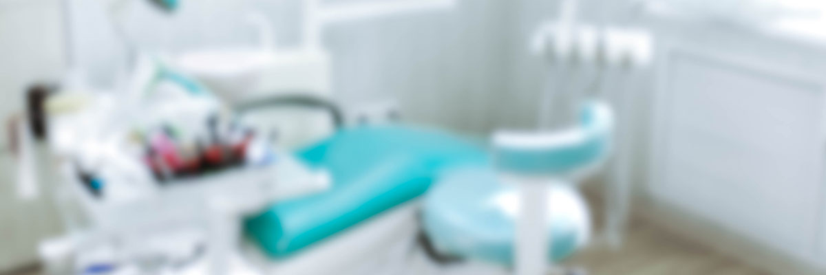 Blurred photo of dental chair and equipment