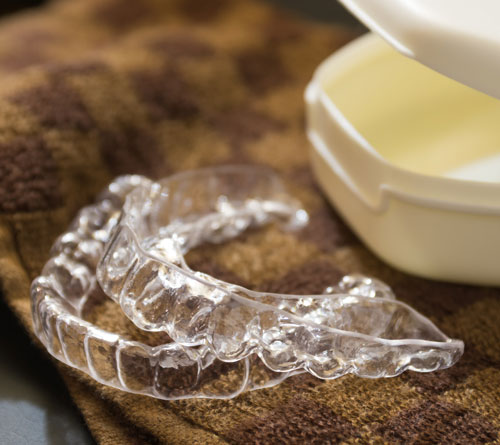 Dental guard sitting on towel in front of case