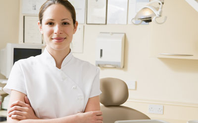 Female dental assistant smiling at camera