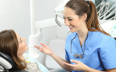 Dental hygienist talking to patient