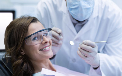 Dentist treating a smiling patient