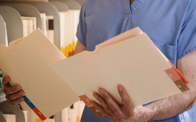 Dentist reviewing patient files