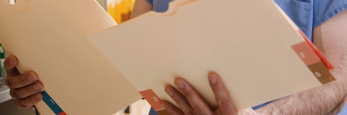 Close up of dentist looking at patient records